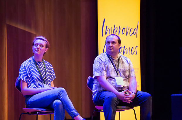 Photo of Kate Ivey-Williams and John Ploughman sat on chairs on a stage.